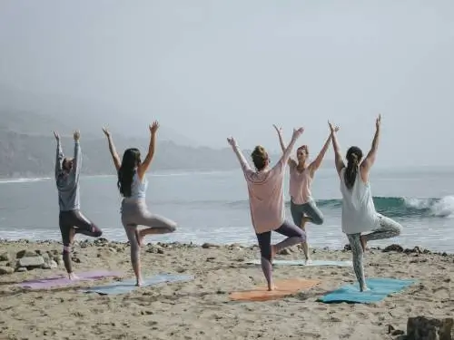 beach yoga a group of people doing yoga on the beach