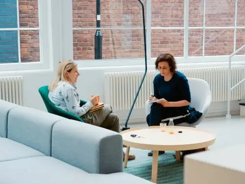 coaching two people sat in a modern office